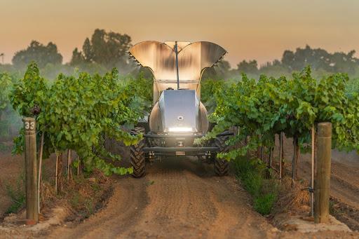 A GUSS automated sprayer sprays an orchard in California.