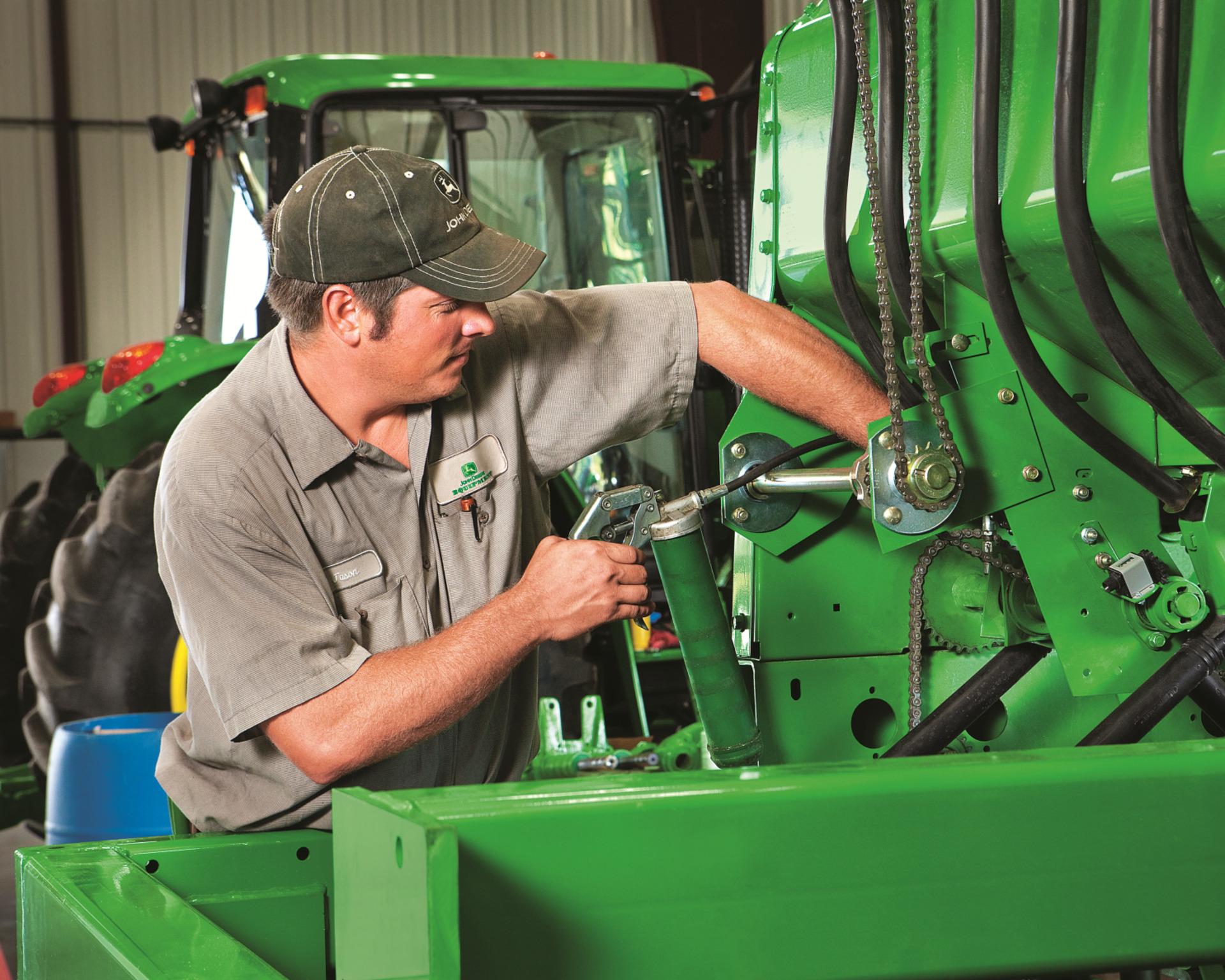 John Deere Technician servicing a tractor