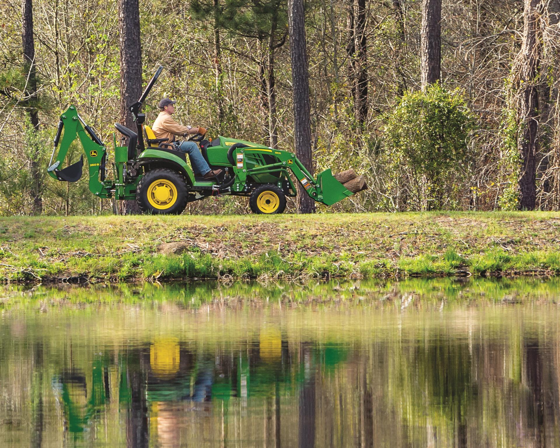 John Deere Compact Tractor being used to haul logs