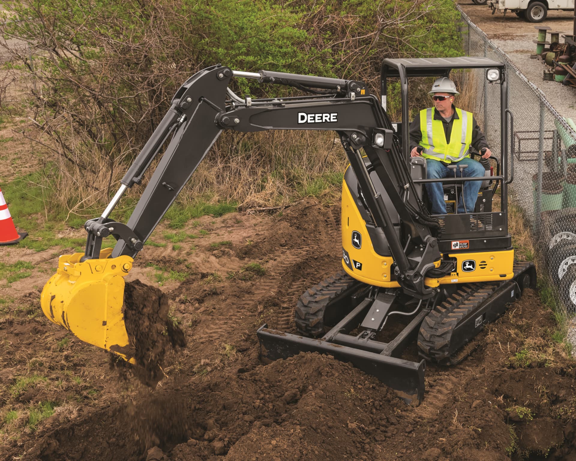 A John Deere 30G Compact Excavator digging a hole.