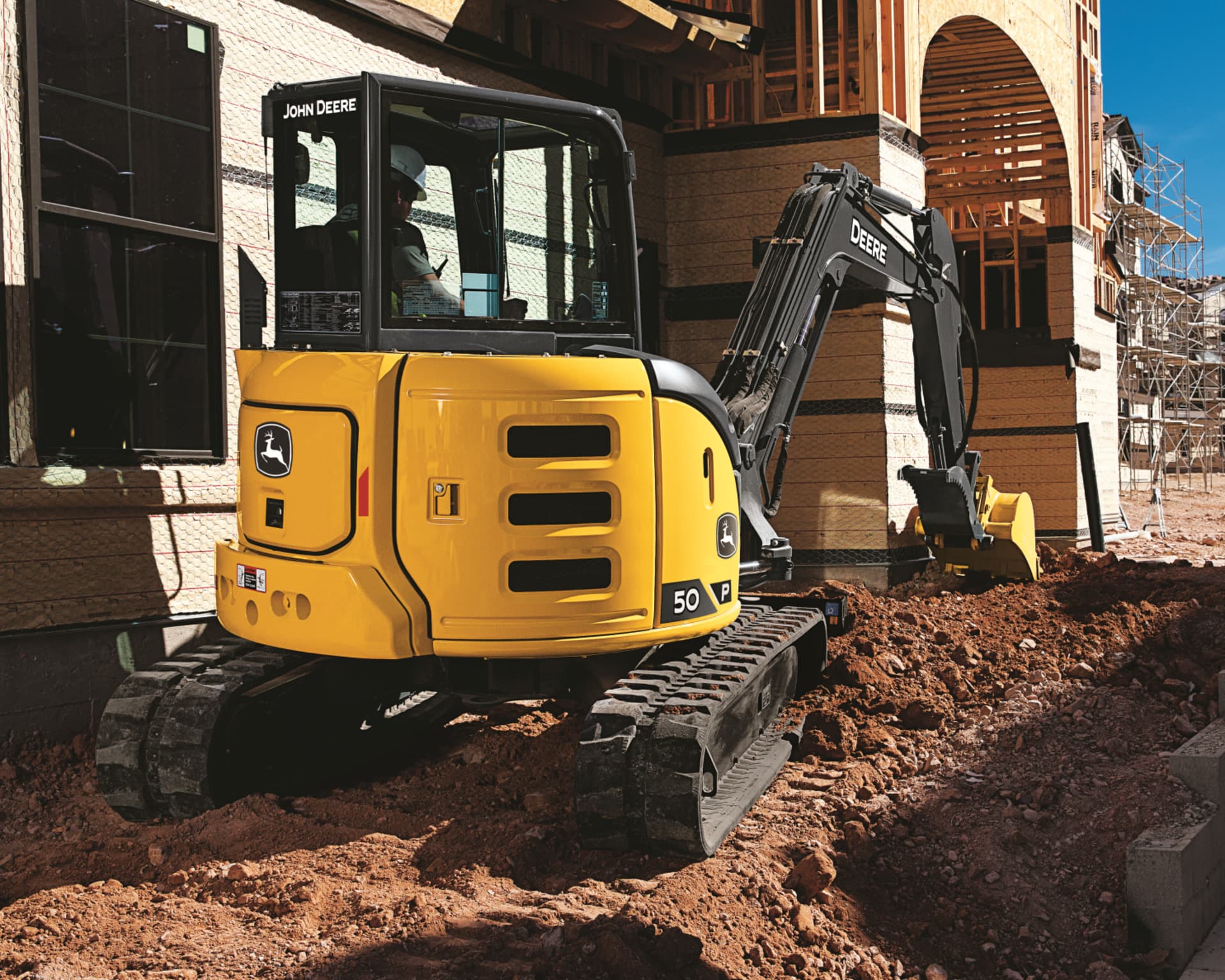 A John Deere 50G Compact Excavator used on a construction site in California.