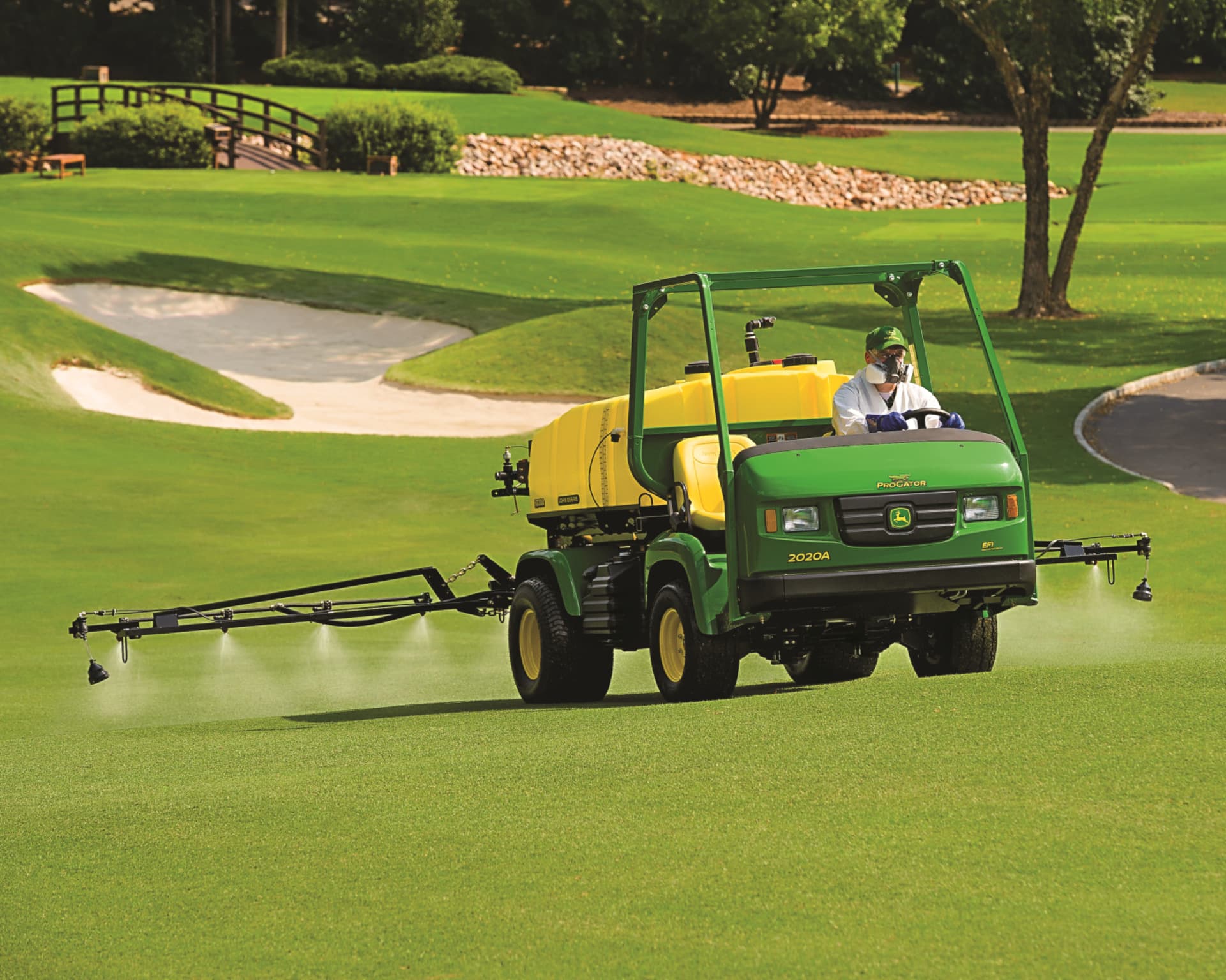 A John Deere Progolf cart with a sprayer works to spray and treat a golf course in California.