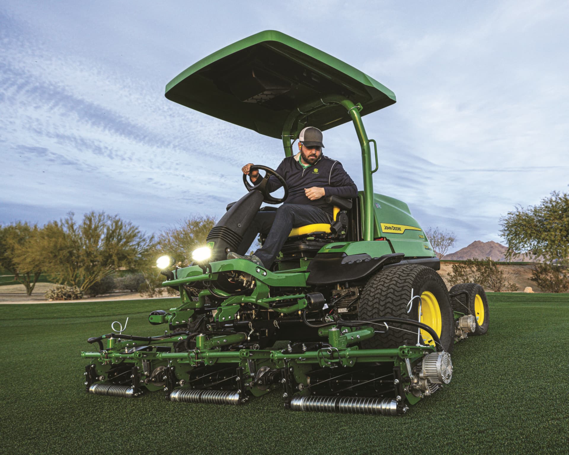 A workers uses a John Deere mower to maintain a golf course in California.