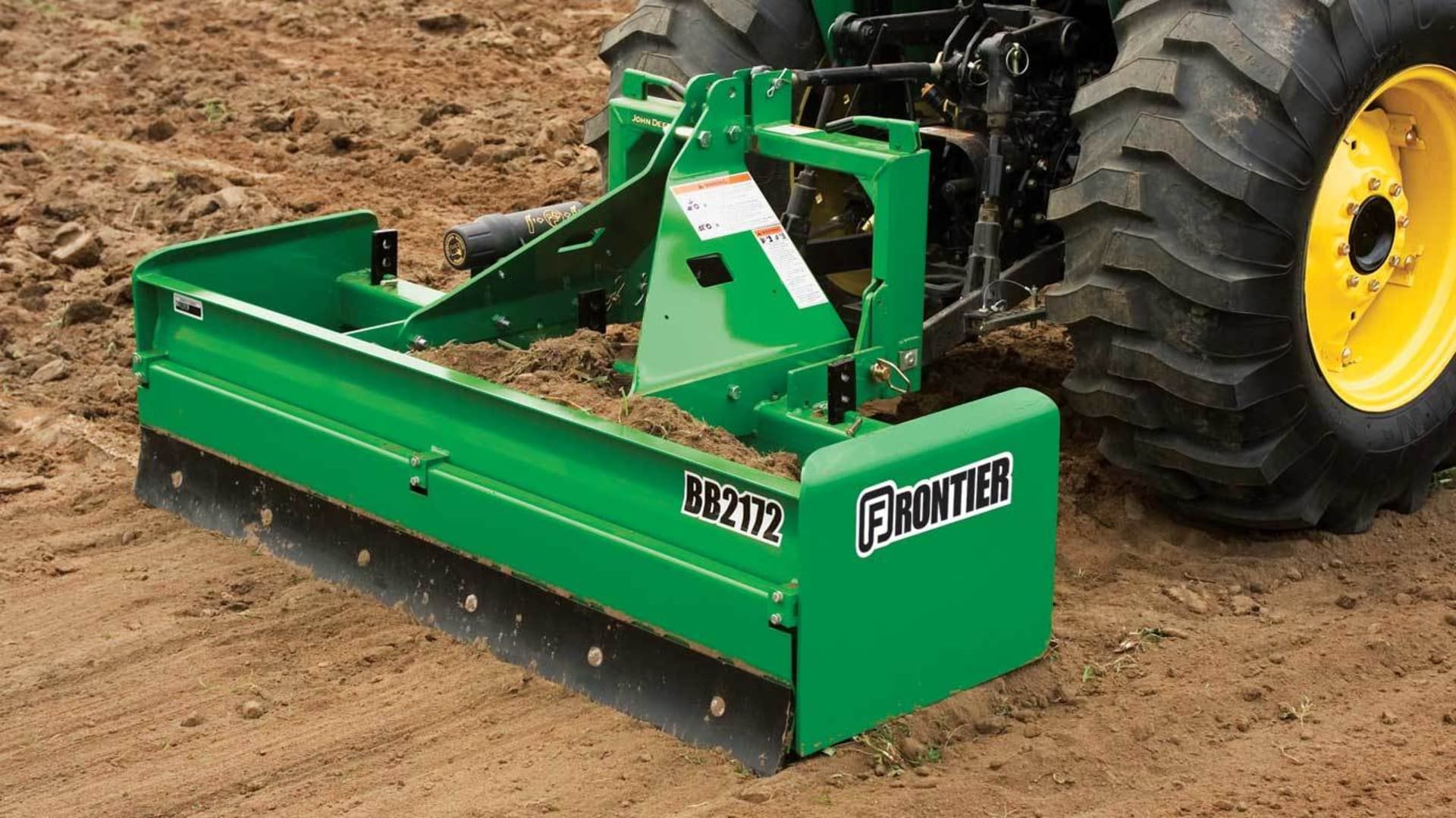 A box blade attached to a John Deere 4044M preps the ground for orchard planting in California.
