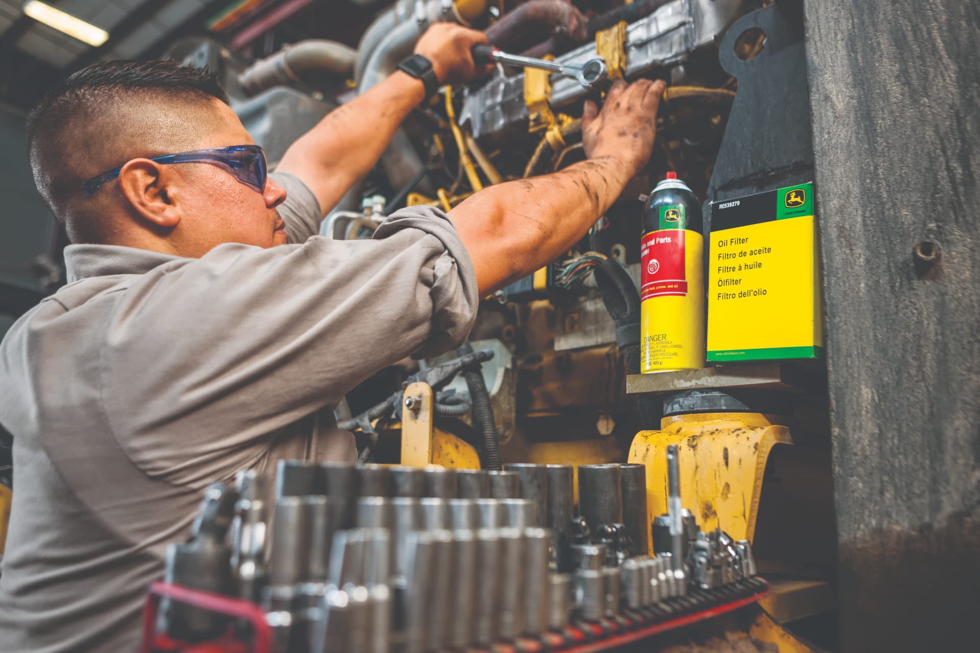 A worker inspects a machine during a routing warranty inspection.