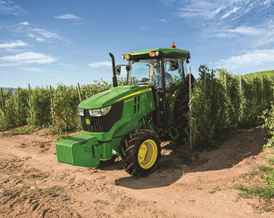 A compact tractor moves through a field using precision ag.