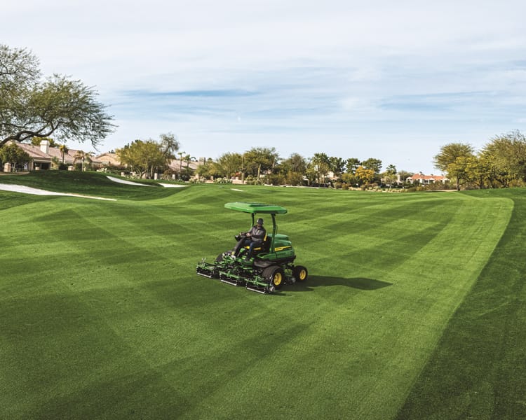 A worker on a golf course maintains the greens during winter in California.