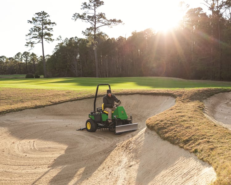 A John Deere bunker rake works on a golf course in California.