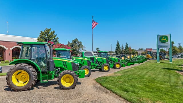 Belkorp Ag Farm to Table A Belkorp Ag dealership with many John Deere equipment models in front.