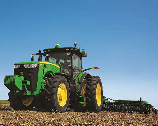A row crop tractor with GPS guides through a California field.