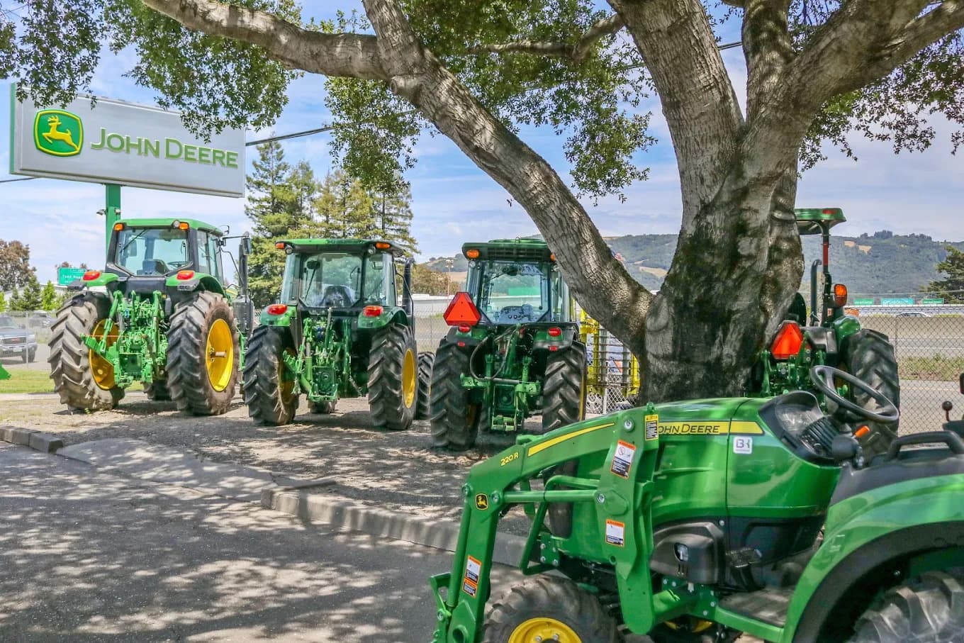A collection of John Deere tractors sits at a Belkorp Ag dealership in California.