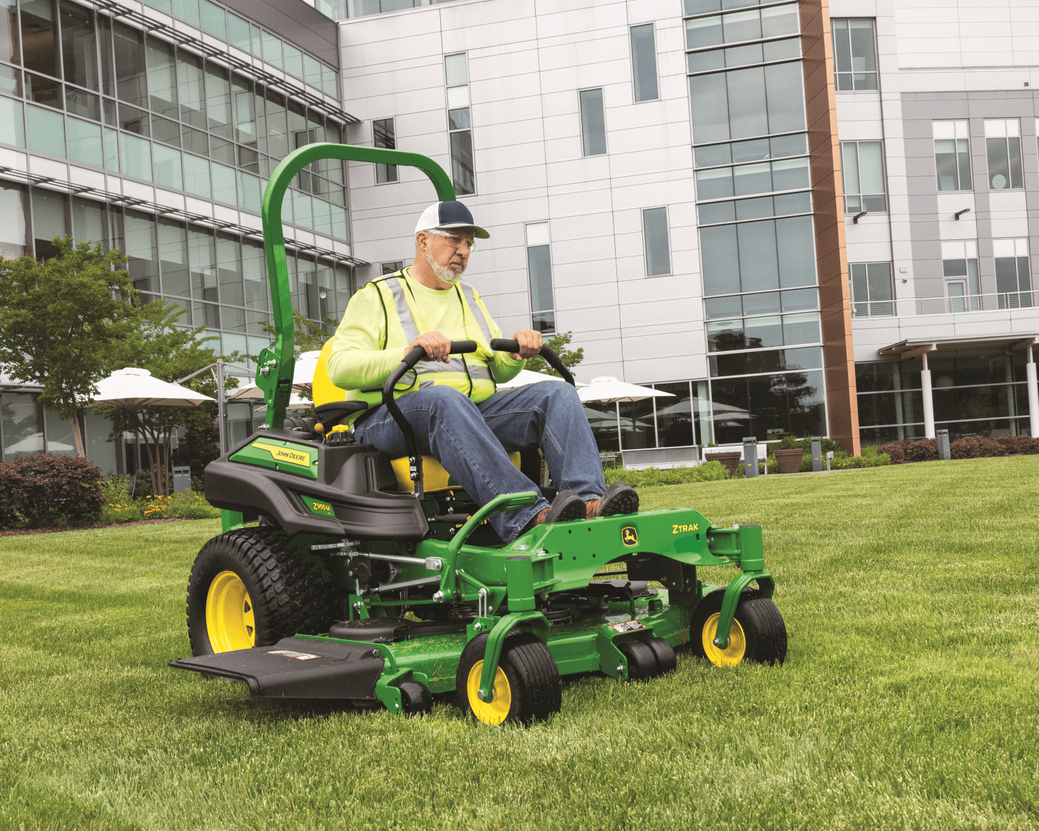 A worker operates a John Deere Z955M in California.